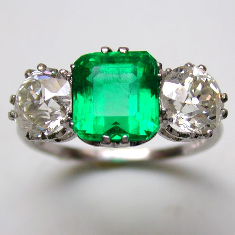 A Three Stone Emerald And Diamond Ring