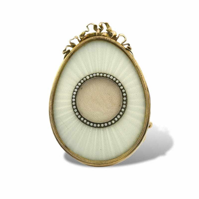 A Fabergé White Enamel Egg Shaped Miniature Frame