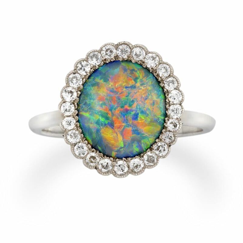An Edwardian Oval Opal And Diamond Cluster Ring