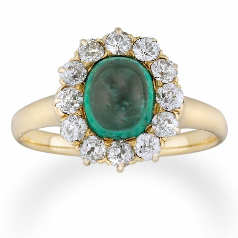 A Turn Of The Century Oval Emerald And Diamond Cluster Ring