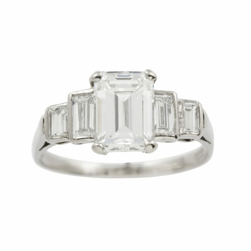 An Emerald-cut Diamond Ring With Diamond-set Shoulders