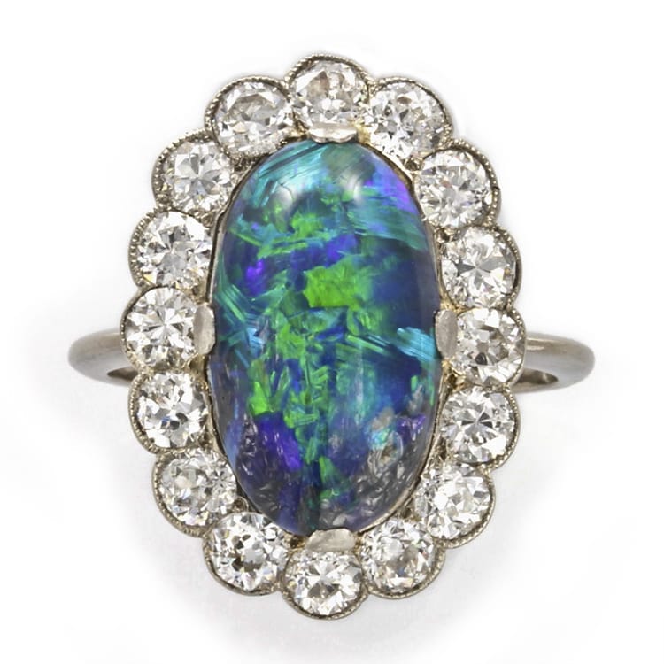 An Oval Opal And Diamond Cluster Ring