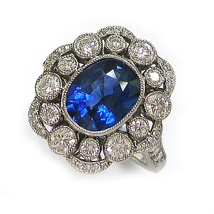 An Oval Sapphire And Diamond Cluster Ring