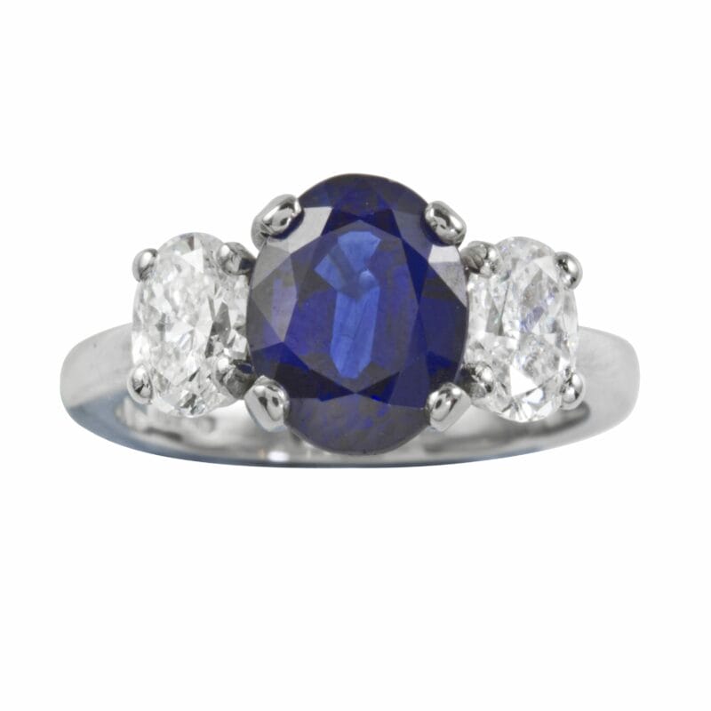 An Oval Sapphire And Diamond Three Stone Ring