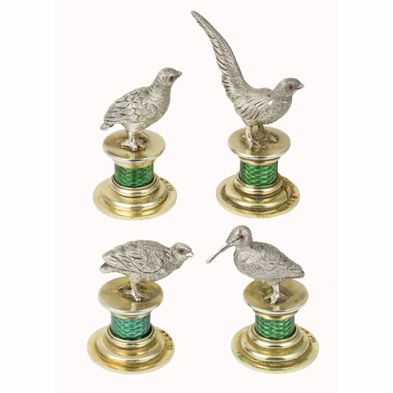 A Set Of Silver Bird Menu Holders