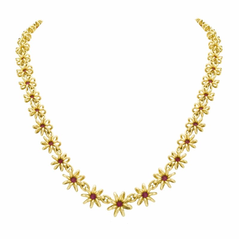 A Yellow Gold Necklace With Ruby Set Flowers