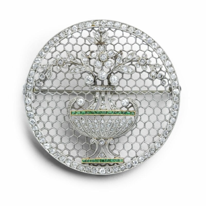 A Diamond And Emerald Circular Brooch