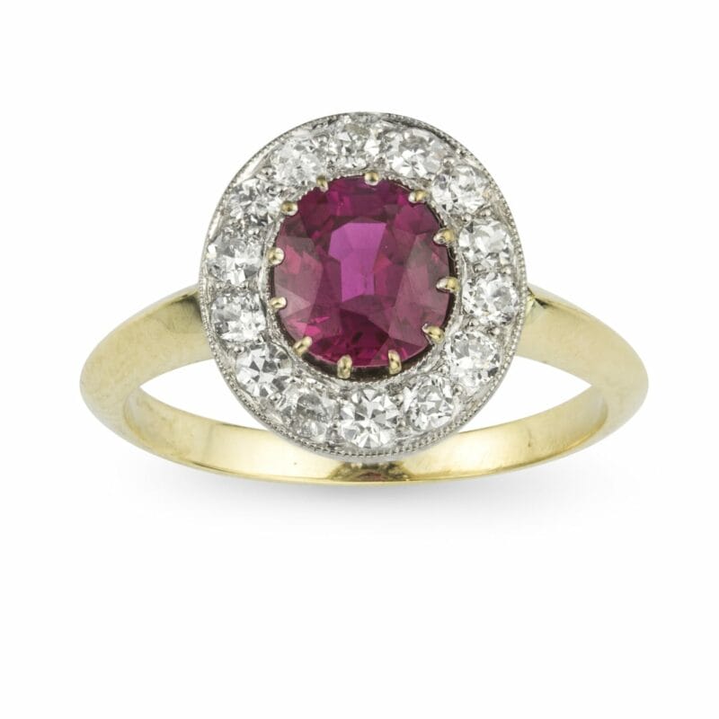 An Oval Ruby And Diamond Cluster Ring