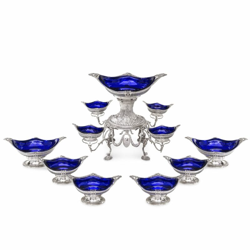 A Victorian Silver Epergne And Suite Of Six Dessert Baskets