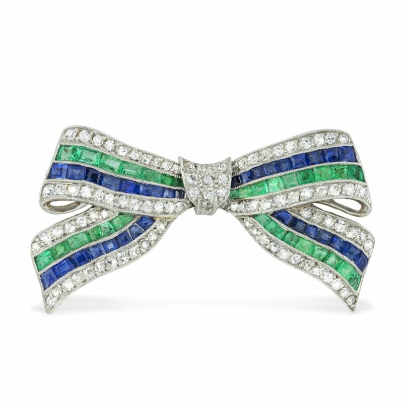An Art Deco Sapphire, Emerald And Diamond Bow Brooch