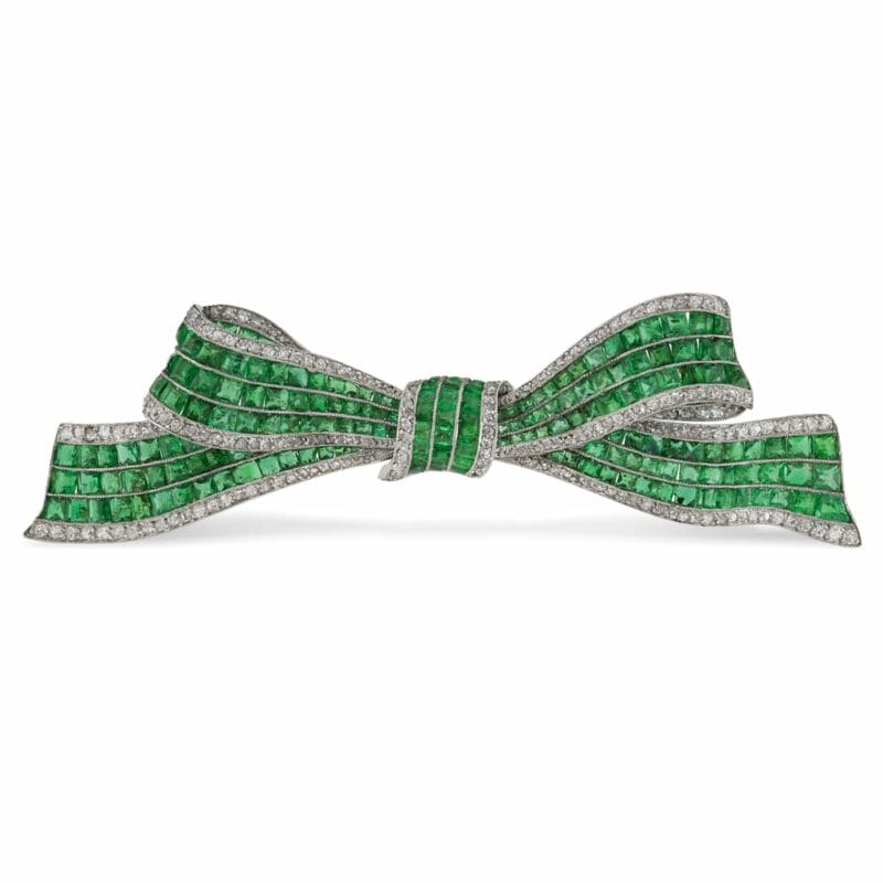 An Art Deco Emerald And Diamond Bow Brooch
