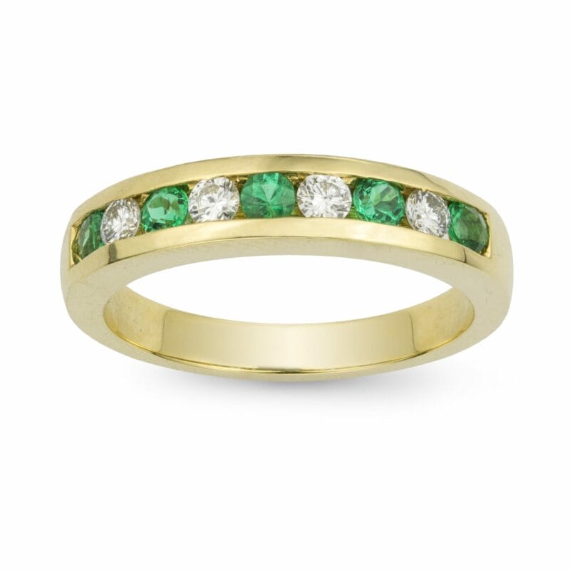 A Yellow Gold Emerald And Diamond Half Eternity Ring