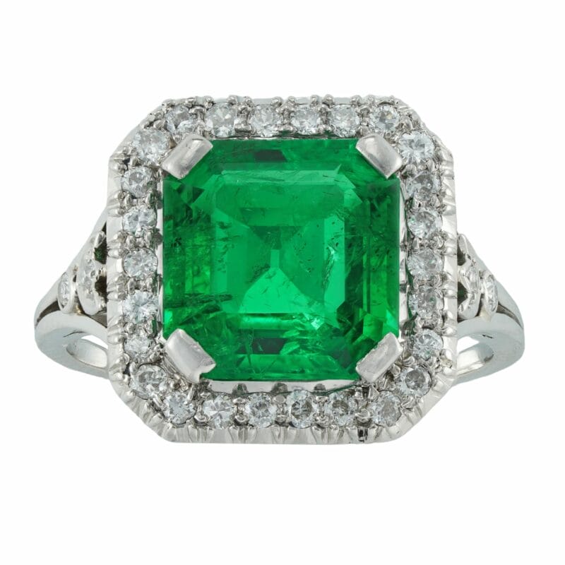 A mid-20th century emerald and diamond cluster ring