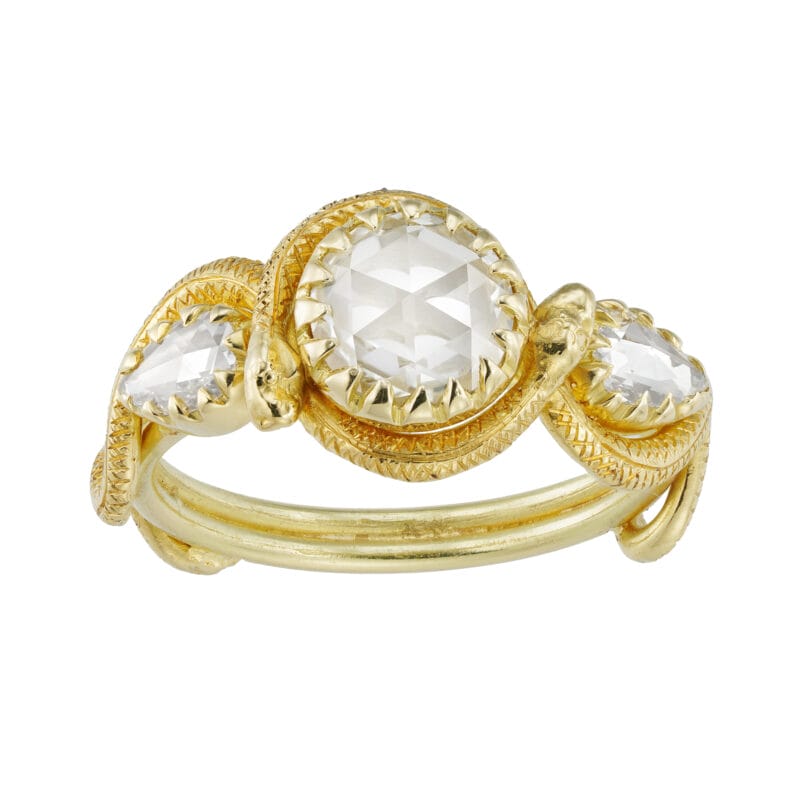 A three stone diamond and gold snake ring