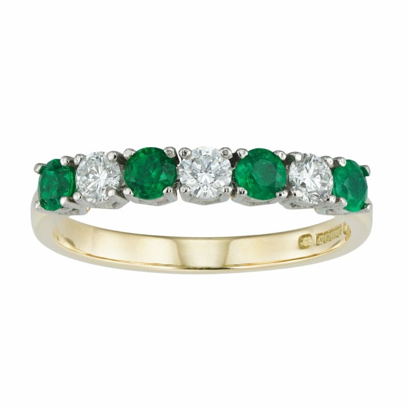 An Emerald And Diamond Seven Stone Ring