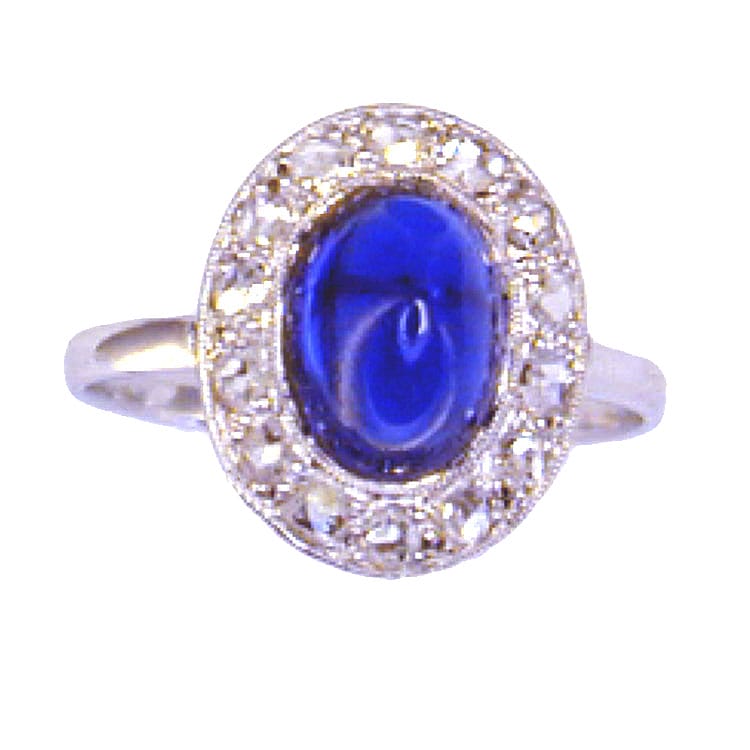 A Cabochon Sapphire And Diamond Oval Cluster Ring