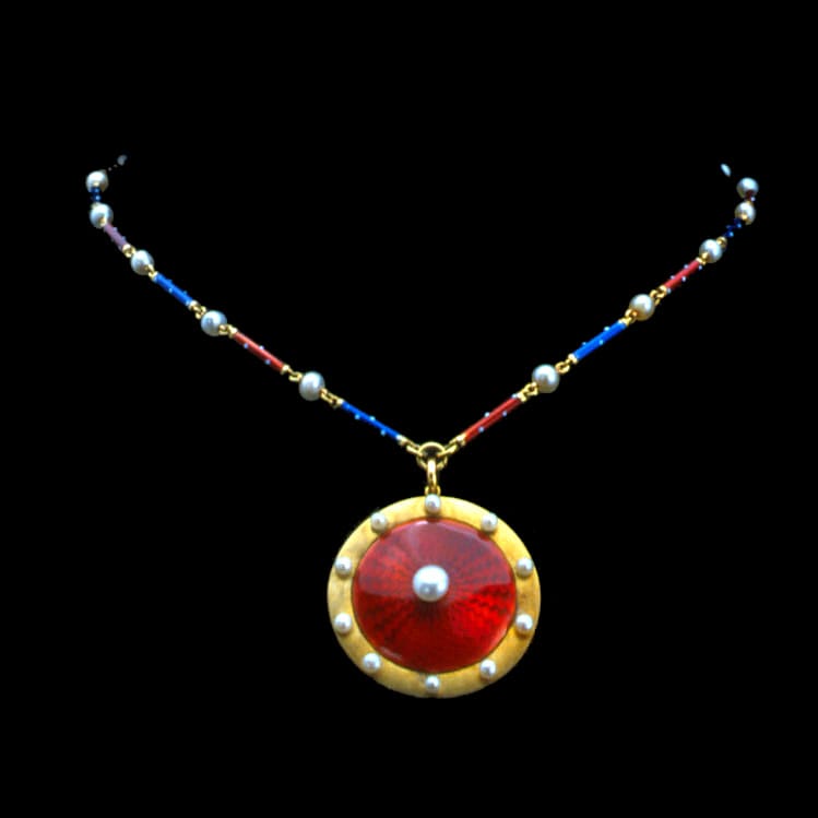 A Circular Pearl And Enamel Pendant With Enamelled Chain