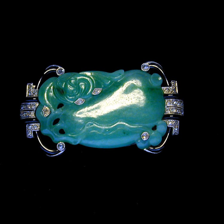 An Art Deco Carved Jade, Diamond And Enamel Brooch
