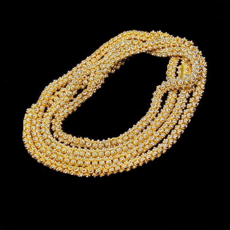 A Yellow Gold Chain With Flower Motif Links