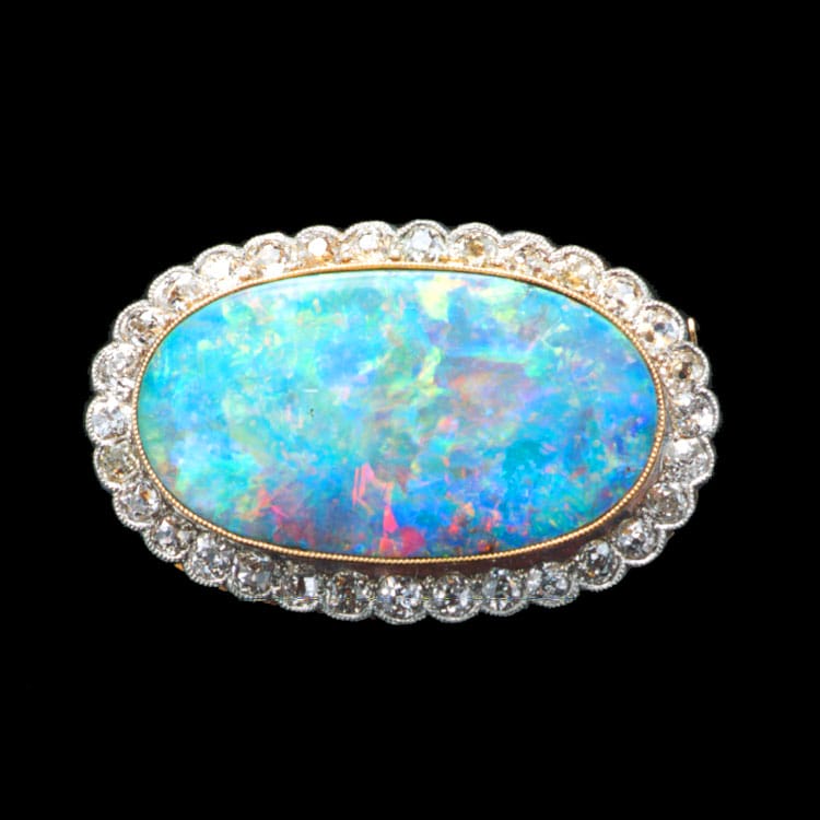 A Turn-of-the-century Opal And Diamond Oval Cluster Brooch