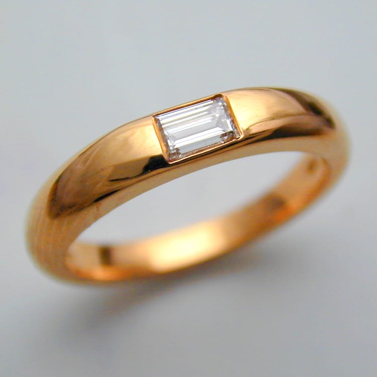 An 18ct Yellow Gold Token Ring Set With A Baguette Diamond