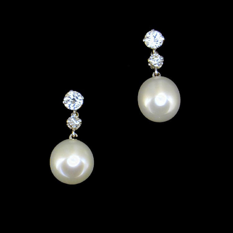 A Pair Of Cultured Pearl And Two Stone Diamond Drop Earrings