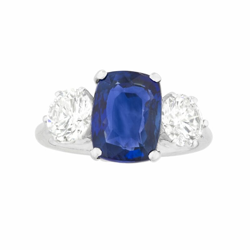 A Cushion Shaped Sapphire And Diamond Three-stone Ring