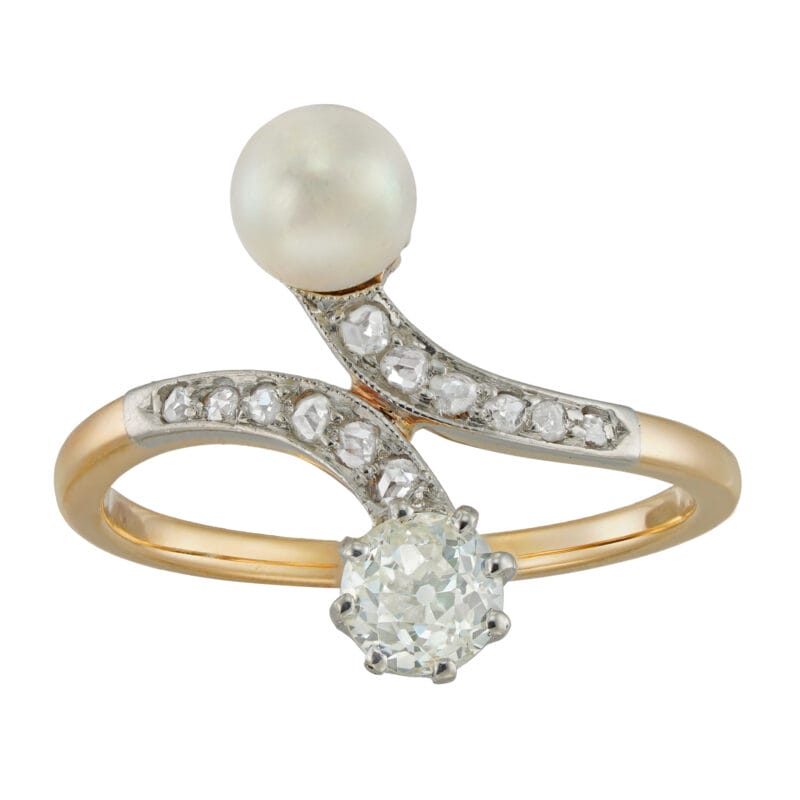 An Edwardian natural pearl and diamond crossover ring
