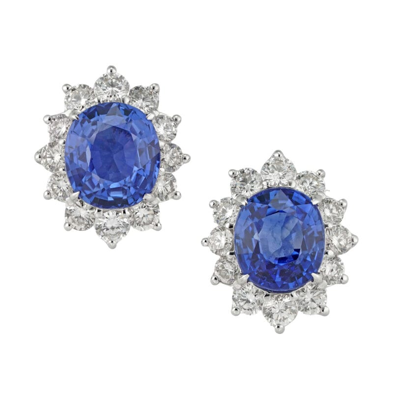 A pair of oval sapphire and diamond cluster earrings